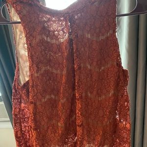 Small, causal, burnt orange top.